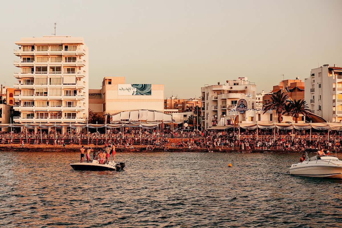 person people riding on boat on sea near buildings during daytime boat