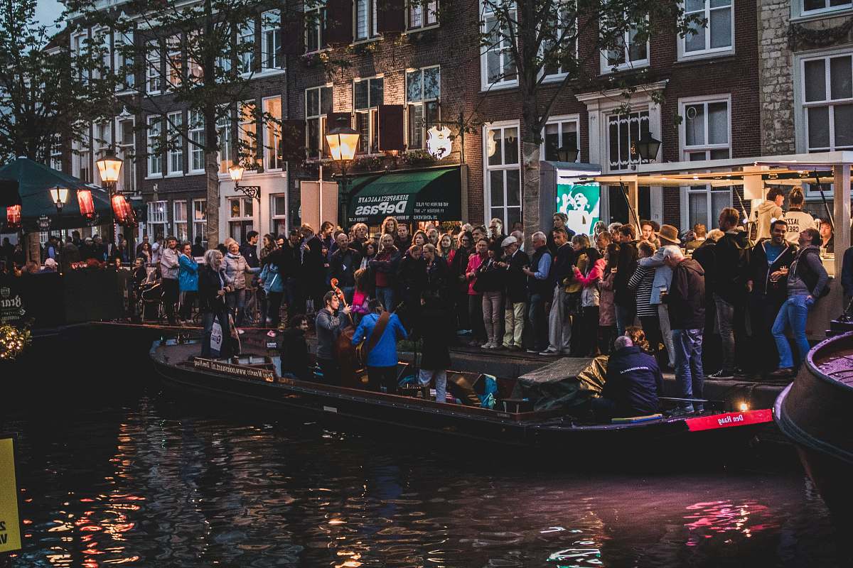 person people standing near body of water boat