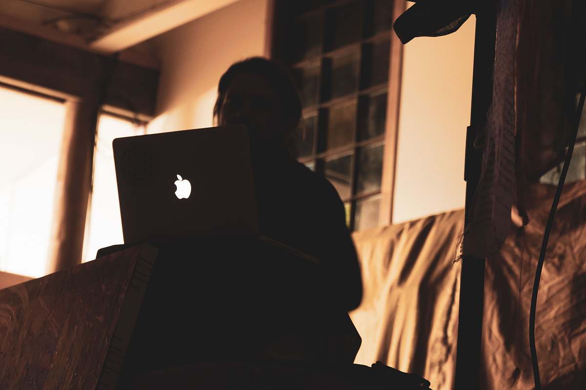 person person using Apple laptop in the room people