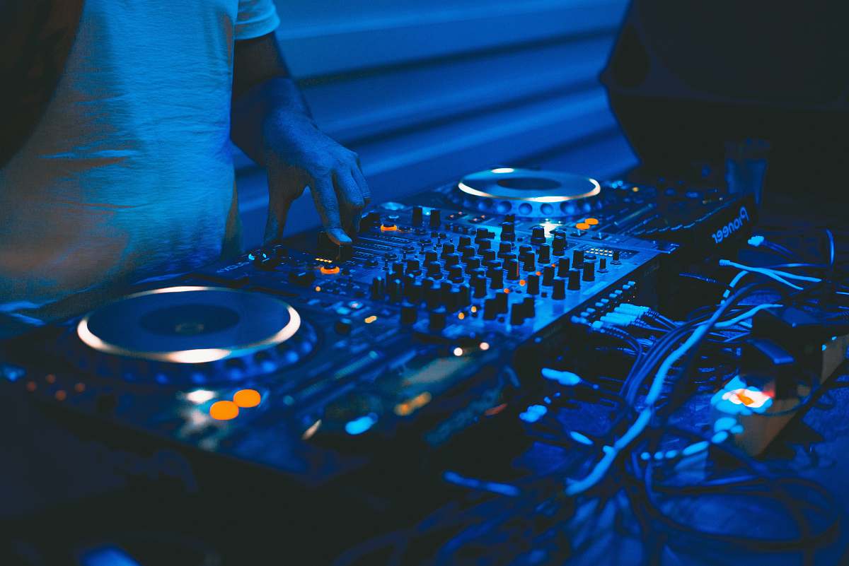 music person using black DJ controller dj