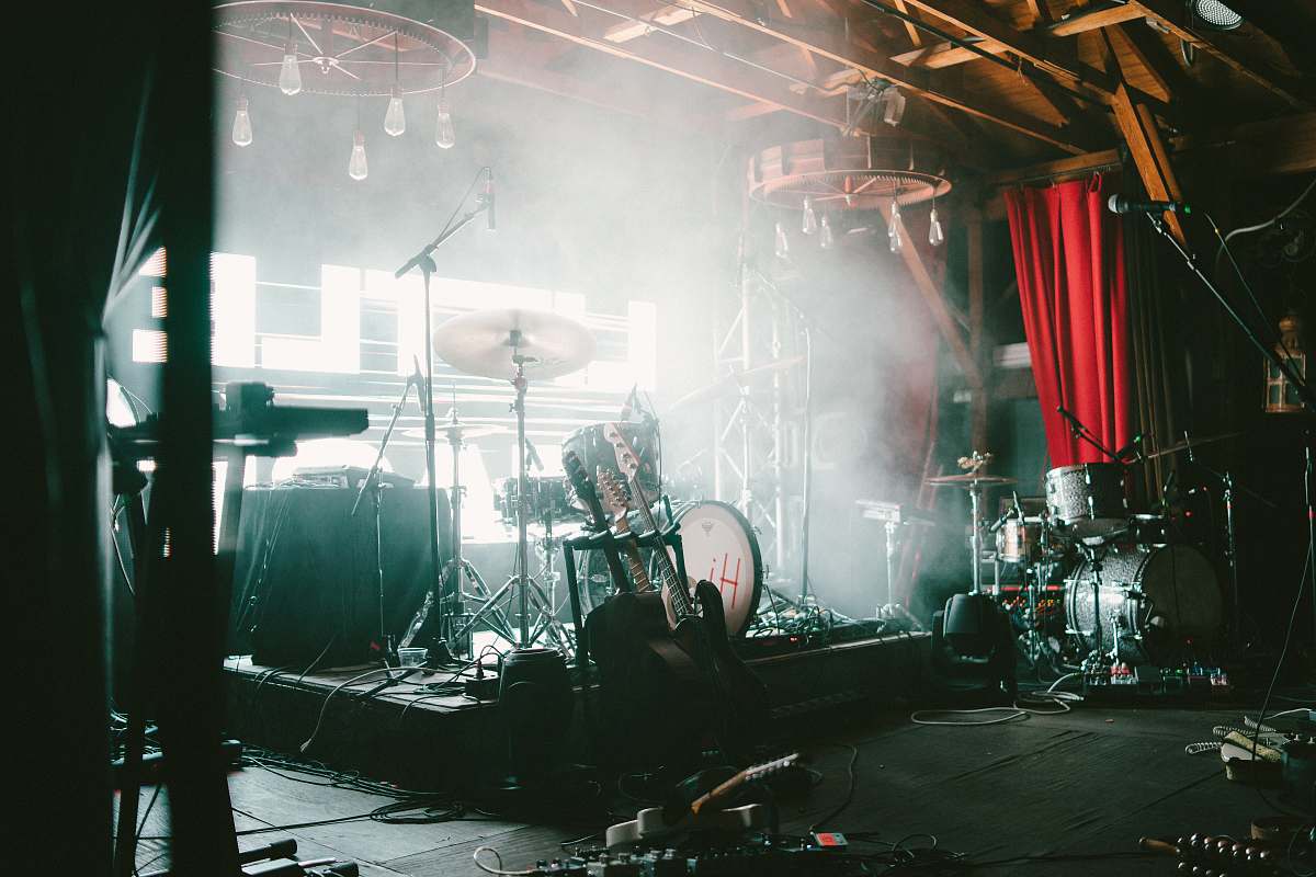 person photo of brown and gray drum set stage
