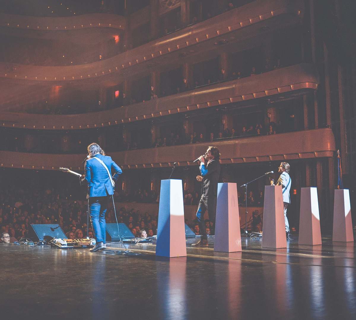 person photography of singing man on stage stage