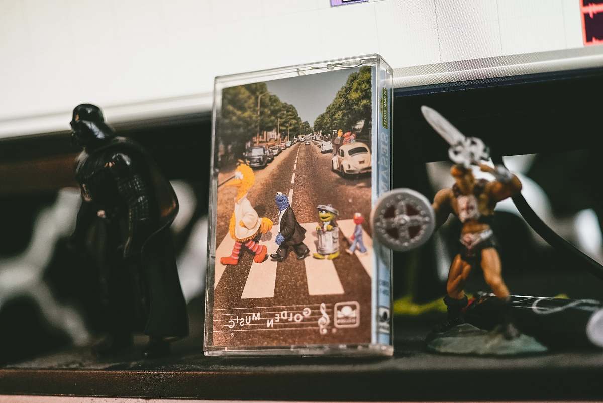 person two He-Man and Darth Vader figurines on table people