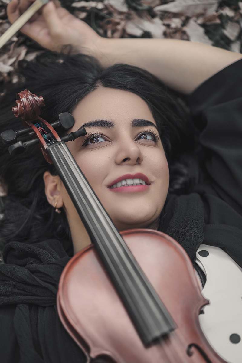 cello violin on woman's chest musical instrument