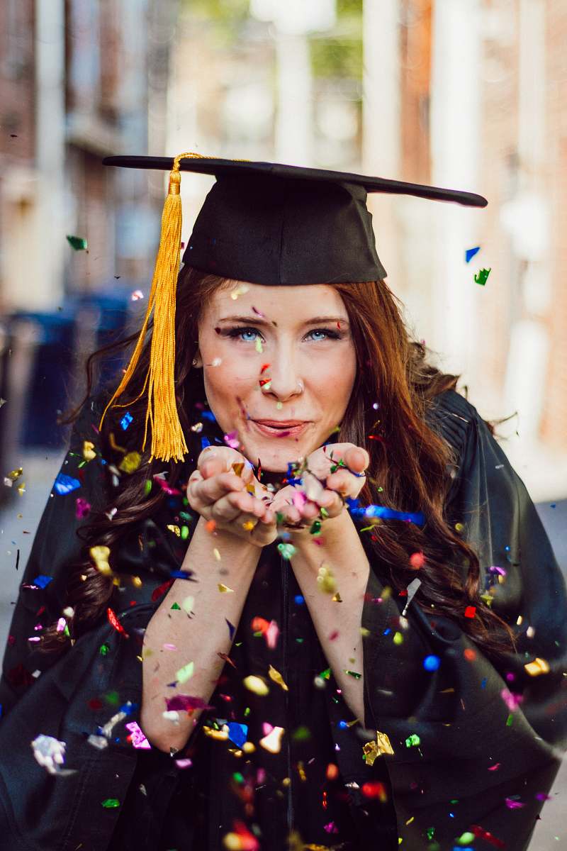 person woman blowing assorted color confettis confetti