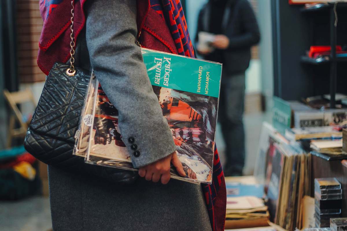 person woman carrying assorted-title magazines clothing
