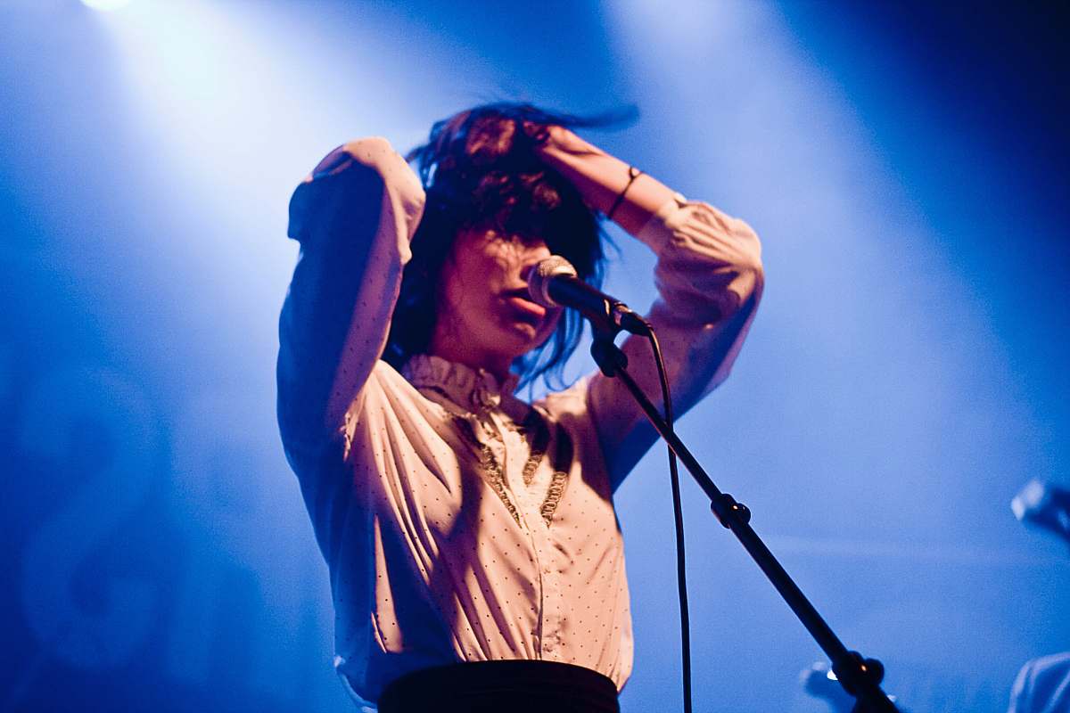 people woman holding her hair in front of microphone person