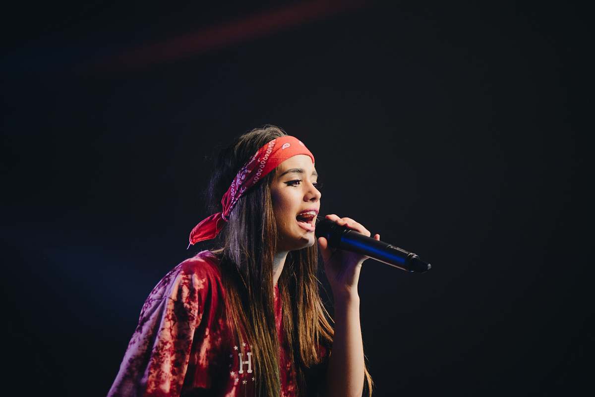person woman in red dress holding microphone people