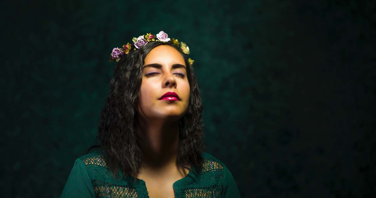 person woman in teal top with floral tiara people