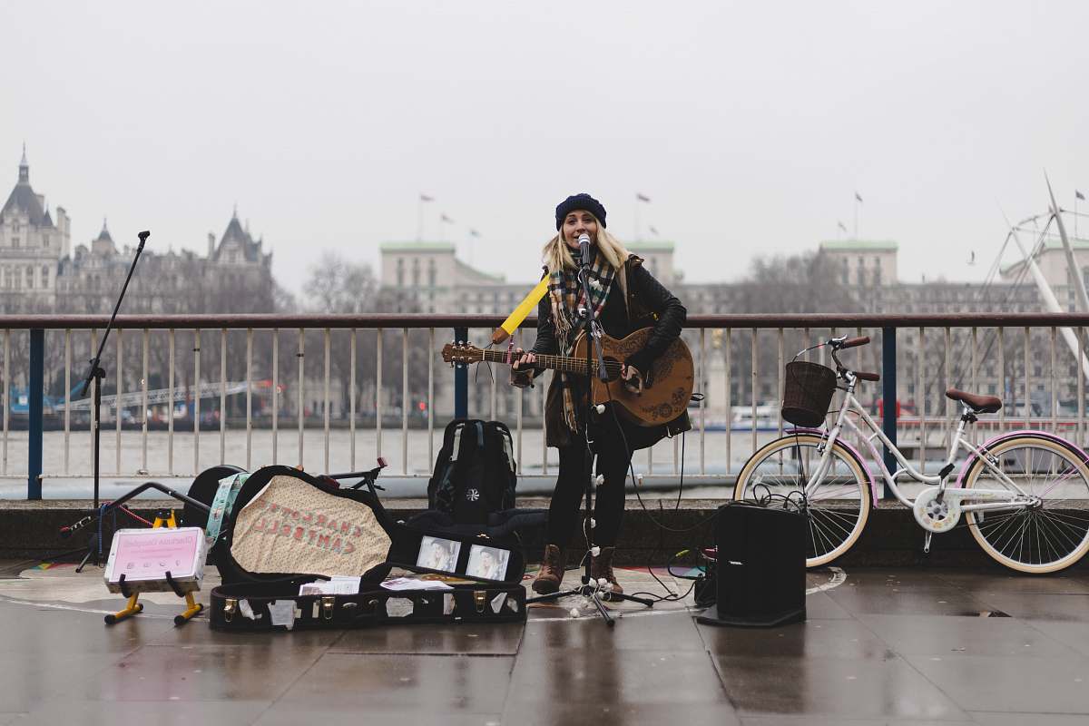 people woman playing guitar bicycle