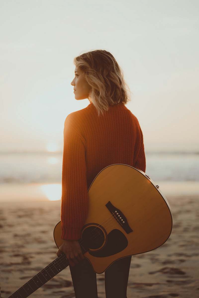guitar woman standing while holding acoustic guitar musical instrument