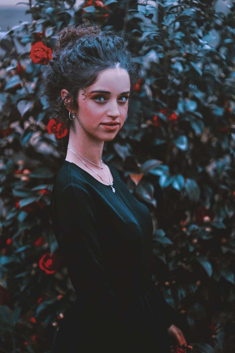 person woman wearing black scoop-neck dress people