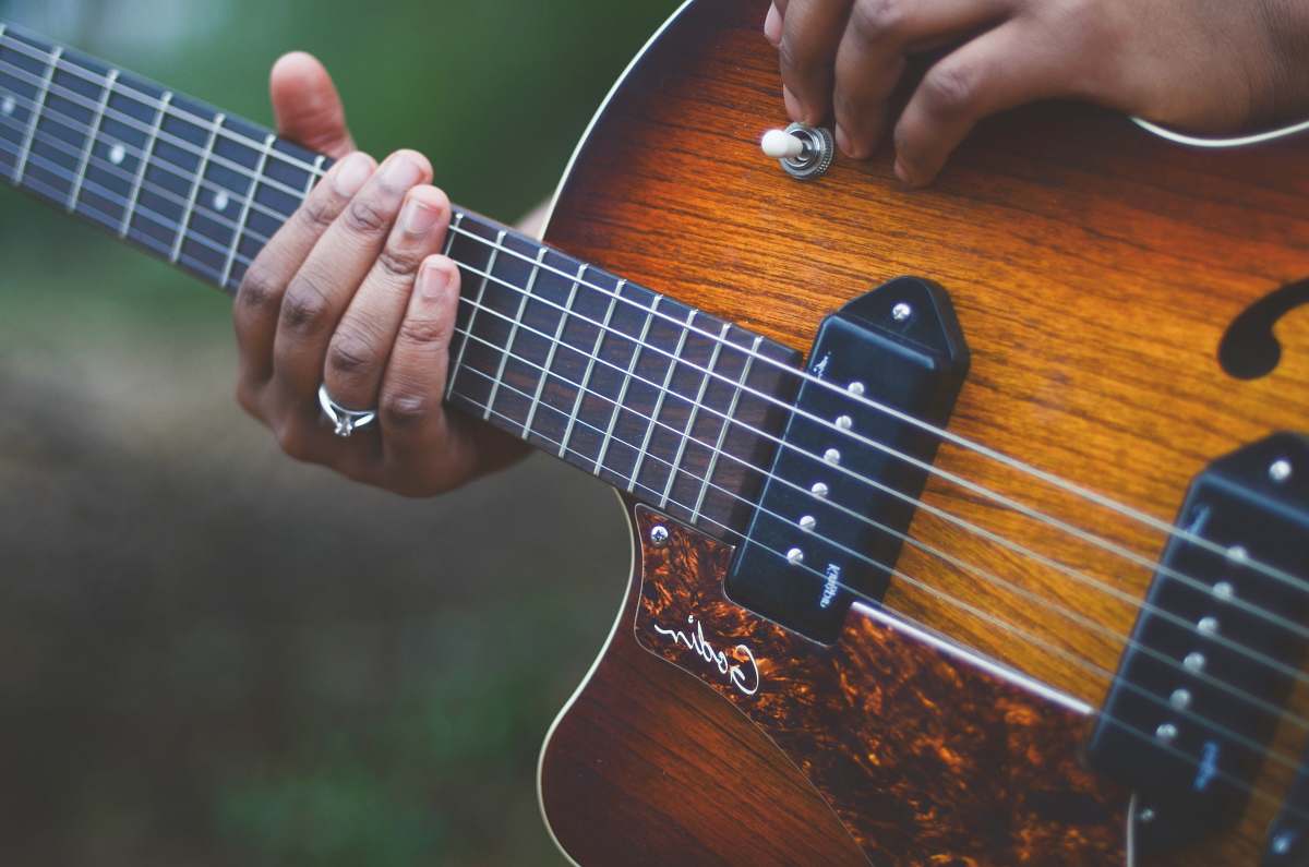 person yellow and brown electric guitar guitar