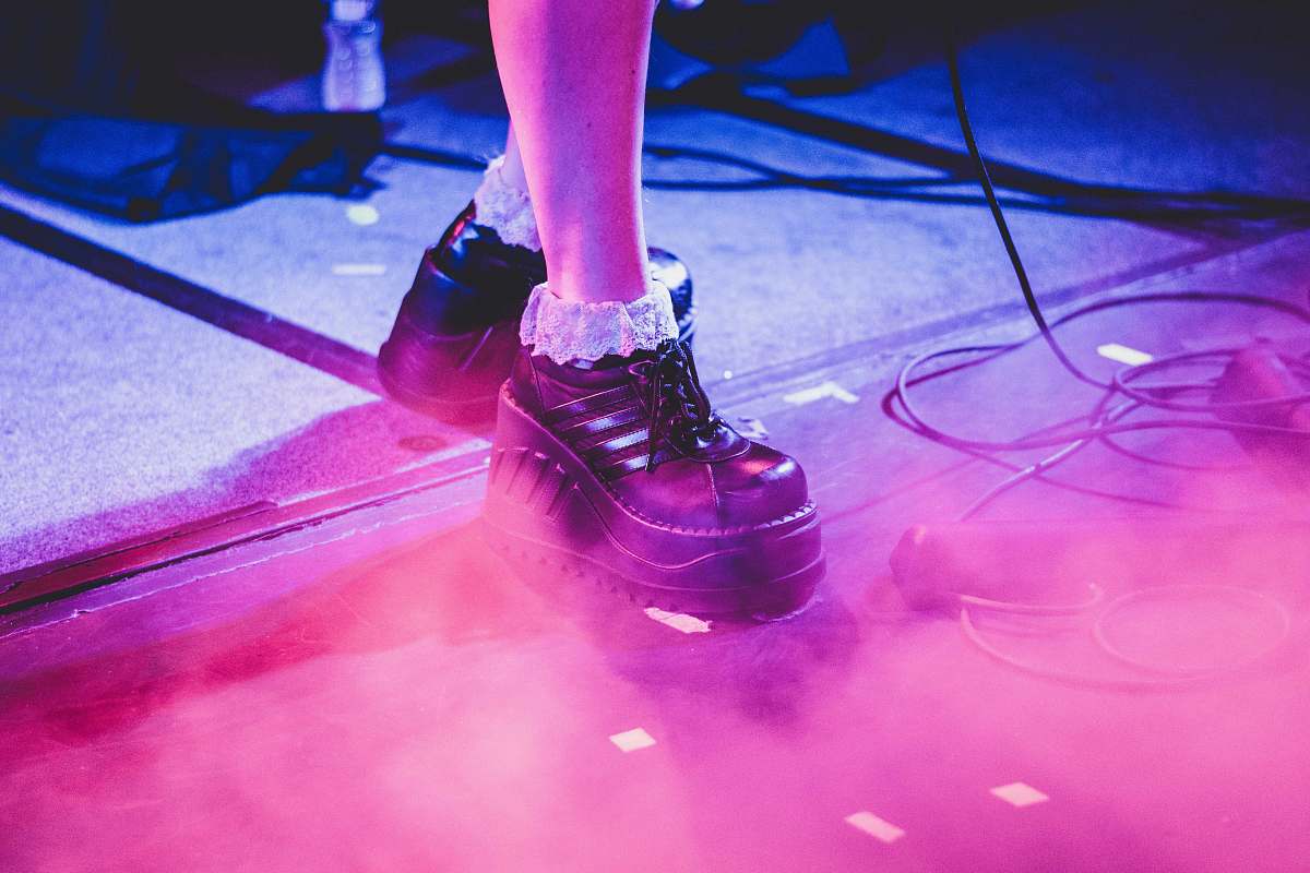laser person wearing pair of black leather dress shoes on gray surface jar
