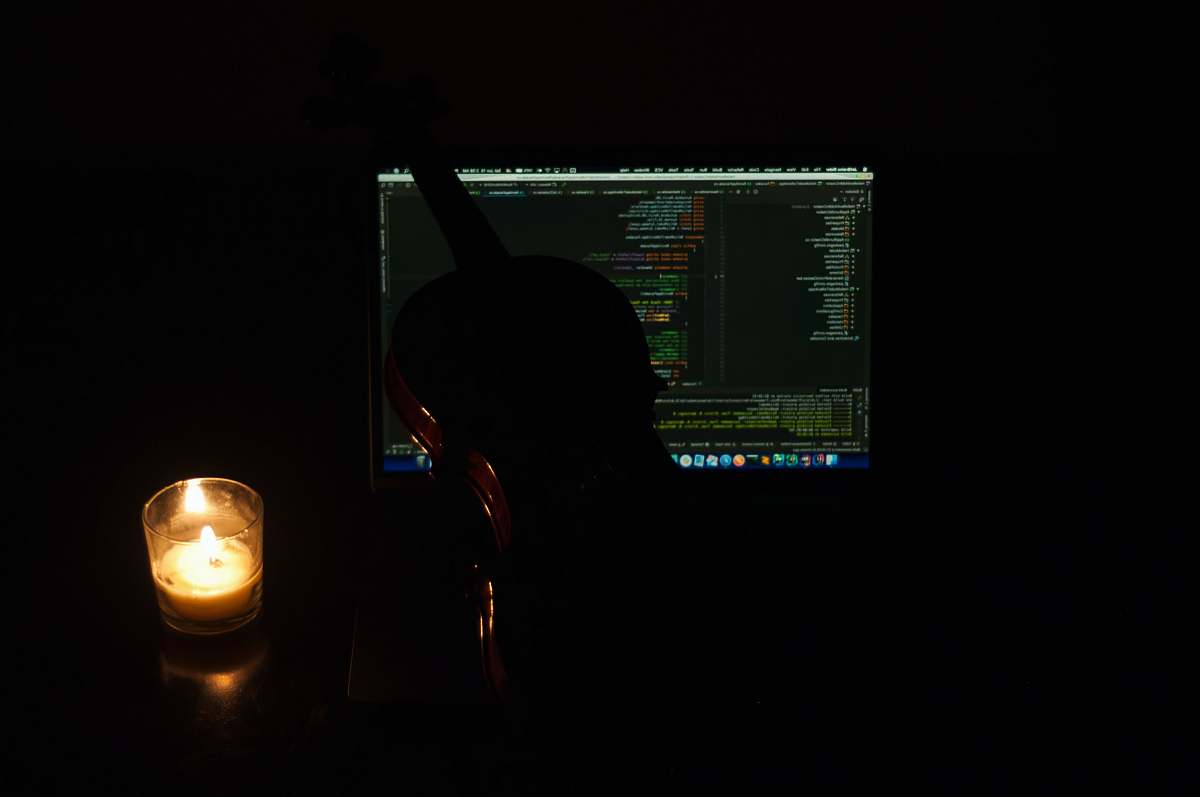 furniture black and brown violin beside lighten votive candle display