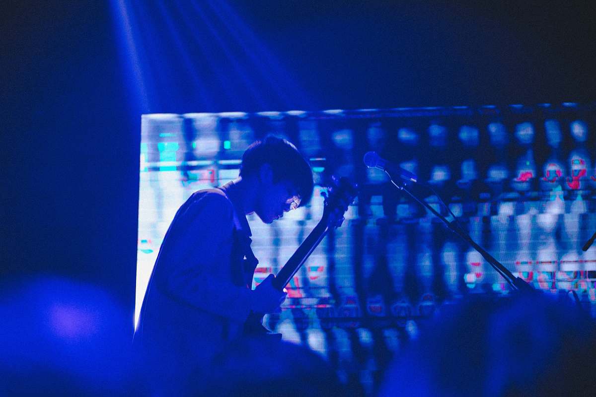 microphone man playing guitar on stage musician
