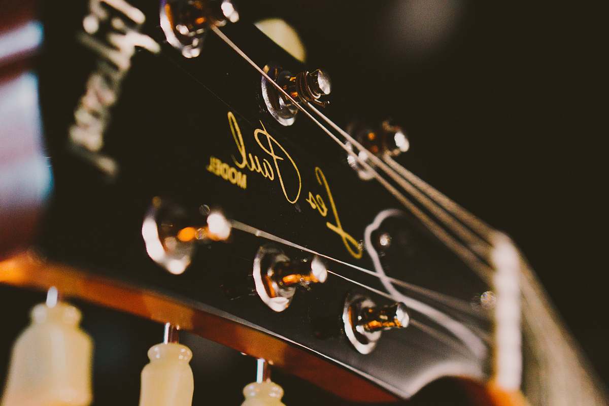 bottle black and brown Gibson Les Paul guitar head stock guitar