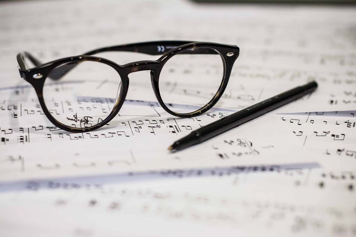 glasses black framed panto-style eyeglasses beside black ballpoint pen savoy