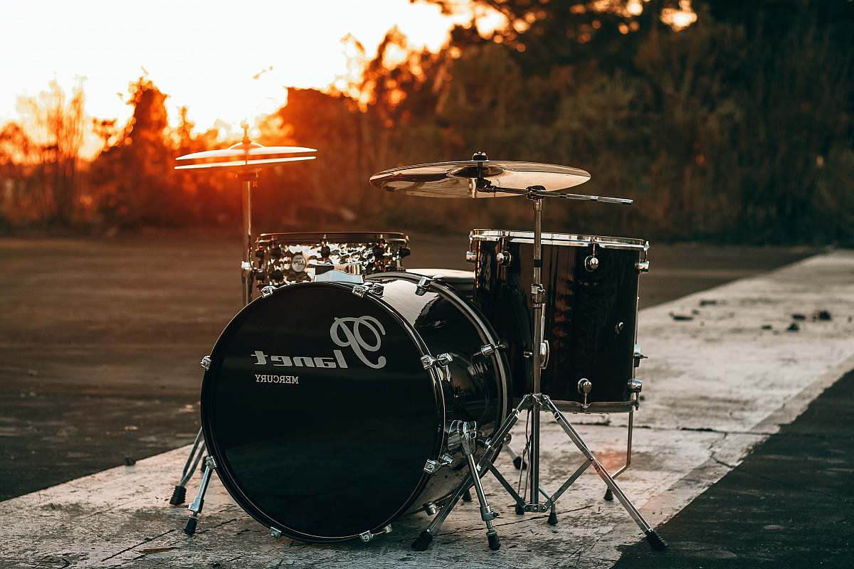 drum black Planet drum kit near trees during sunset fire