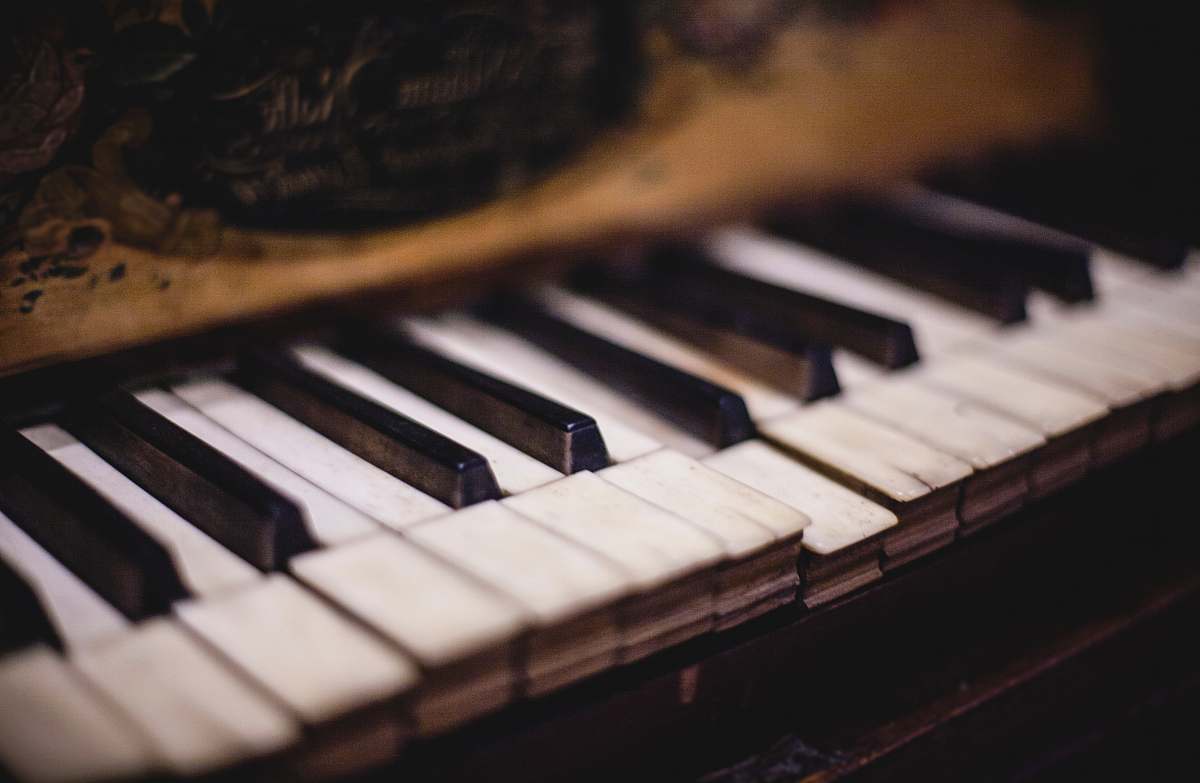 piano close up photo of white and black piano keys grand piano
