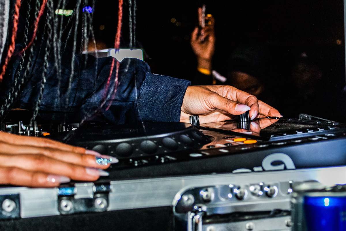human disc jockey controlling DJ controller dj