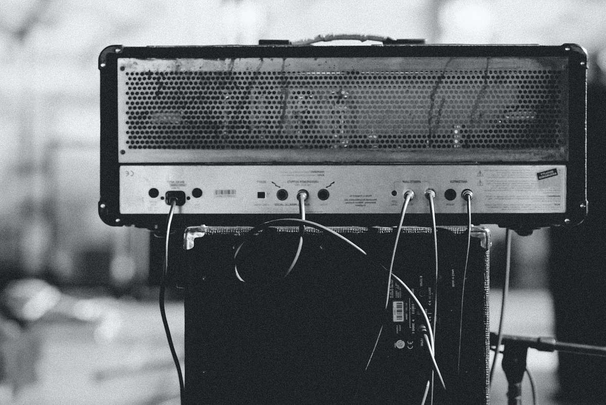human gray and black amplifier on speaker black-and-white