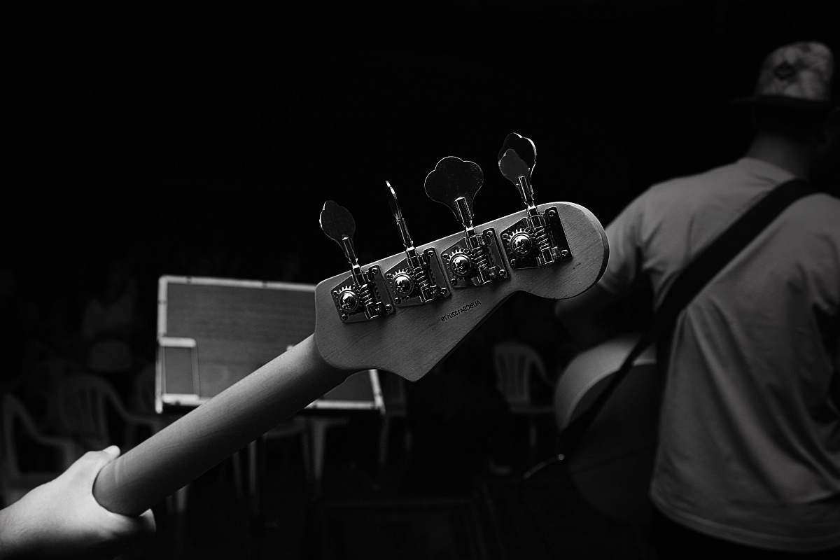 guitar grayscale photography of person carrying guitar black-and-white