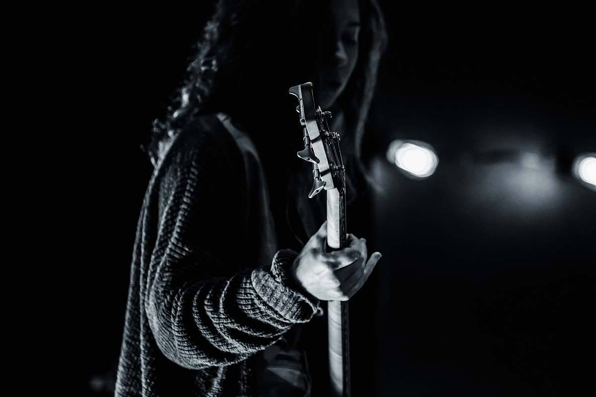 guitar grayscale photography of person playing guitar the woodlands