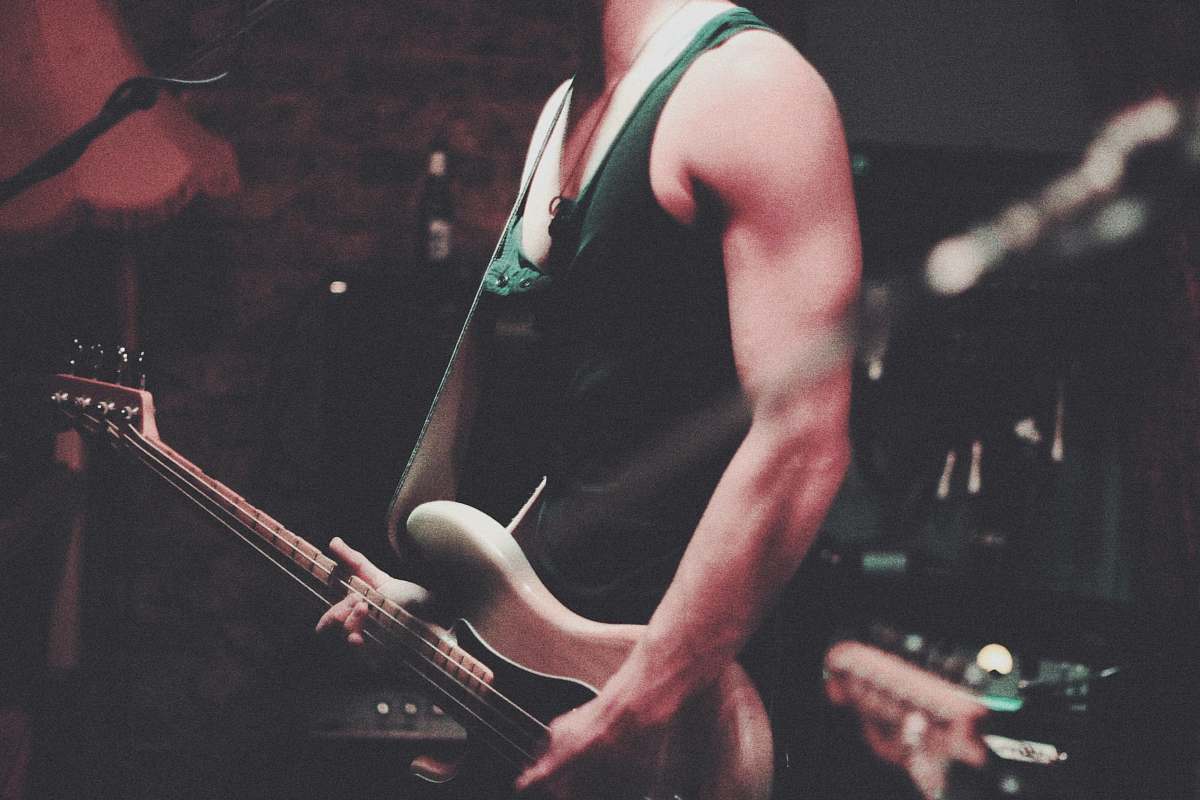 human man holding electric guitar people