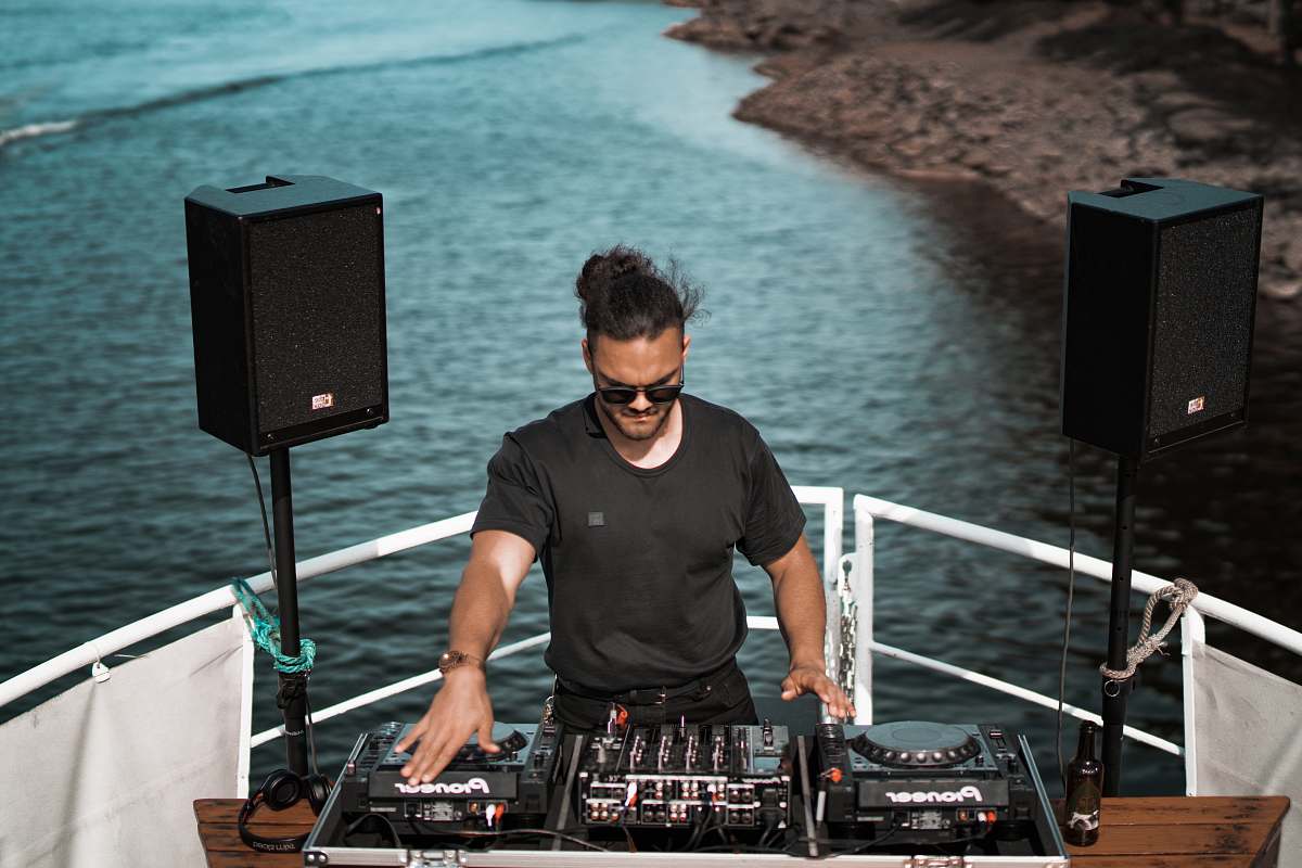 dj man holding mixing console people