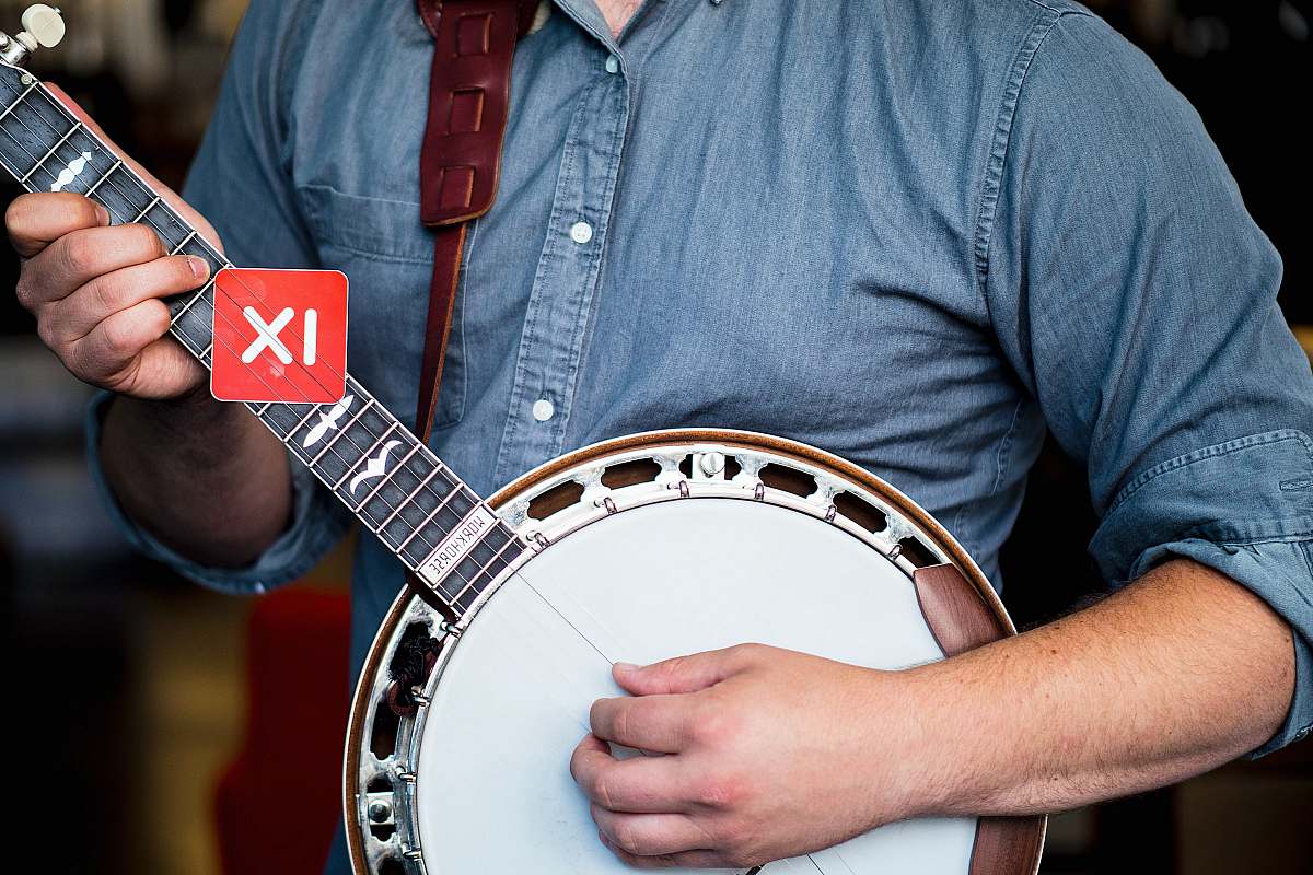 person man playing banjo guitar banjo