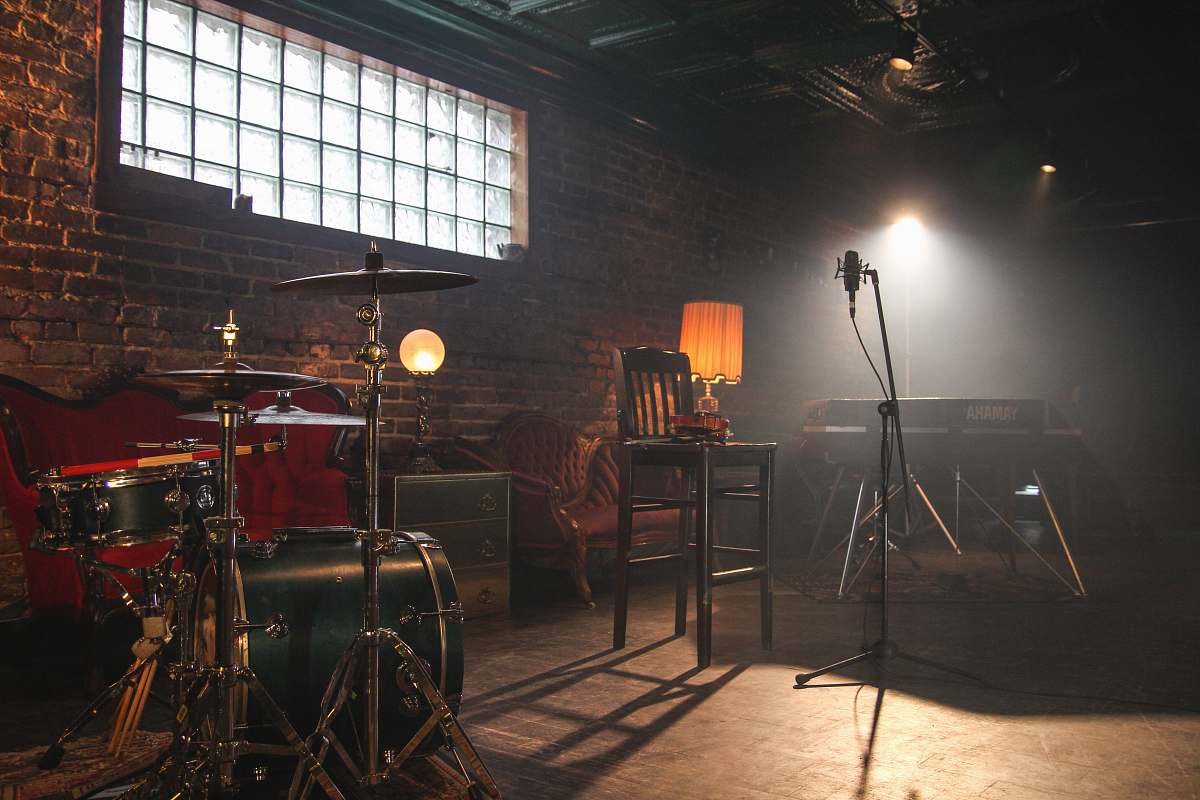 drum music room with lights turned on leisure activities