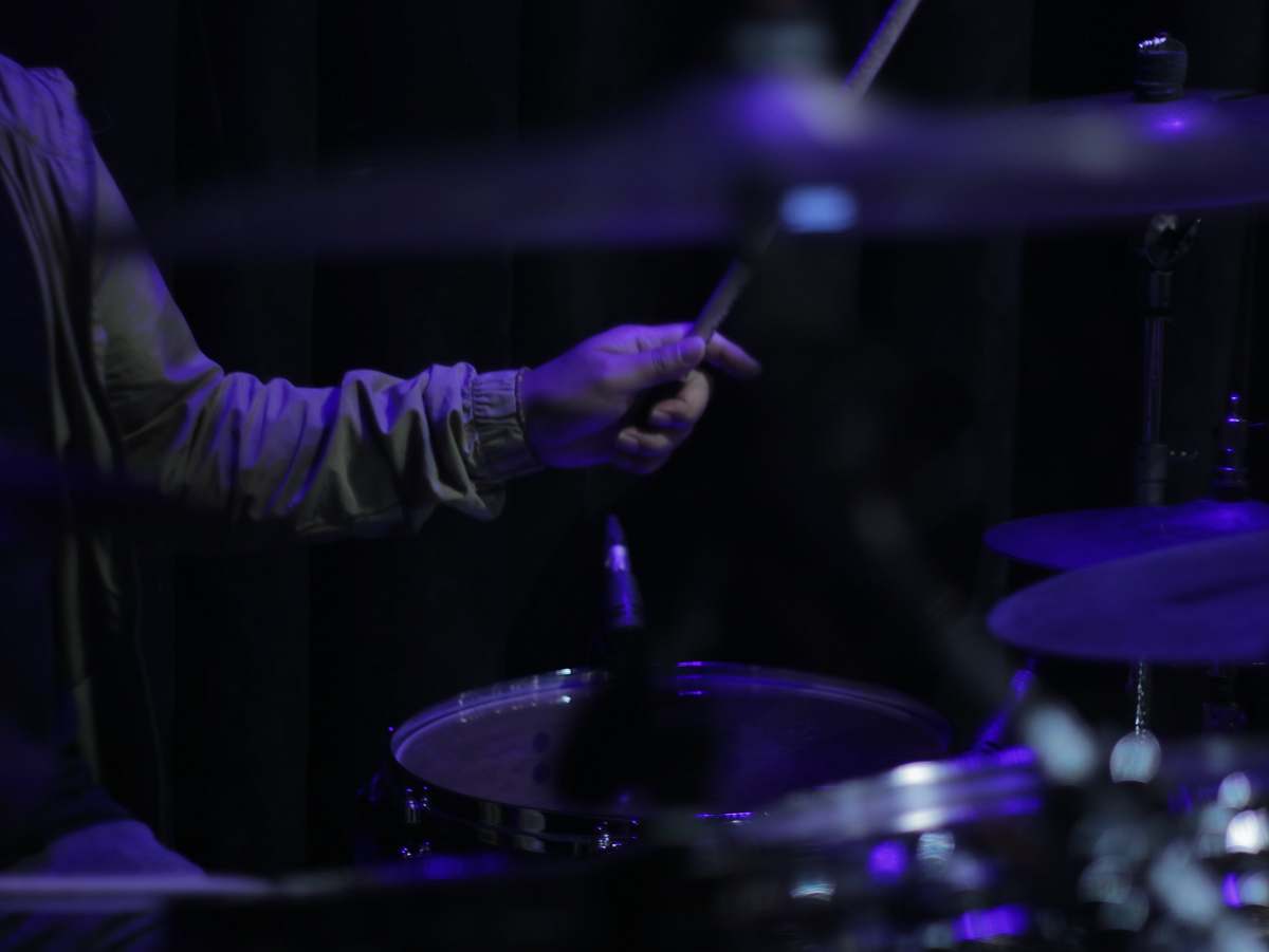 performer person holding drum stick percussion