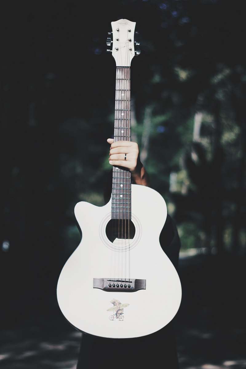 guitar person holding white acoustic guitar electric guitar