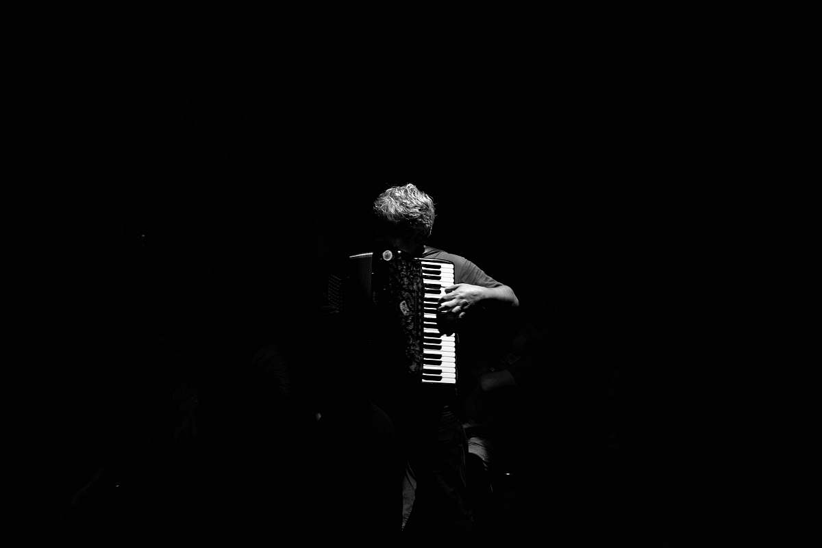 black-and-white person playing musical instrument accordion