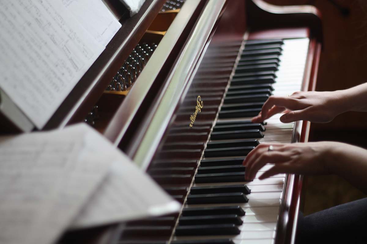 piano person playing piano musical instrument