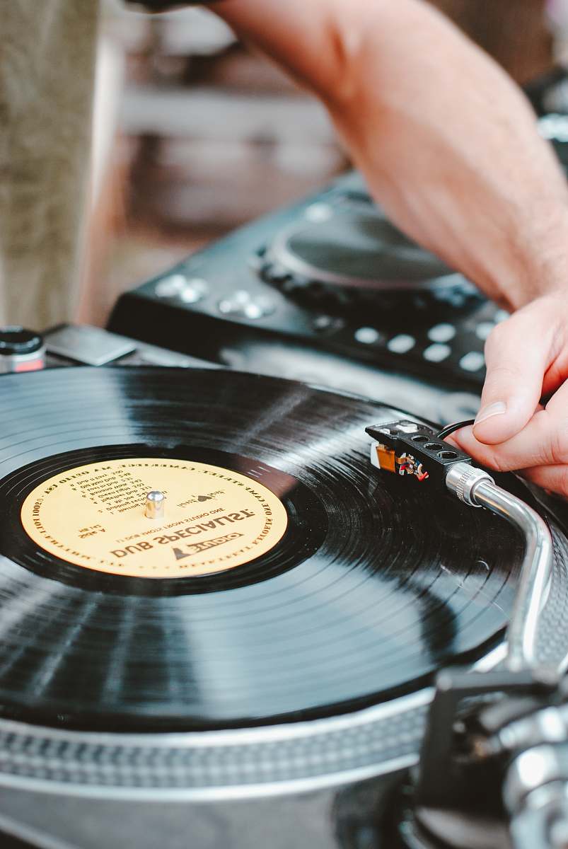 record person playing turntable vinyl