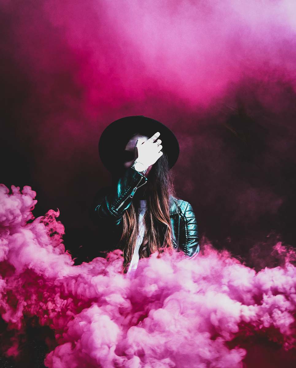 pink person standing around pink smokes smoke