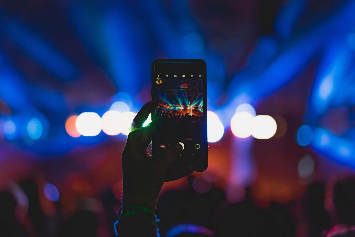 indoor person taking photo of live concert abraham hostel tel aviv