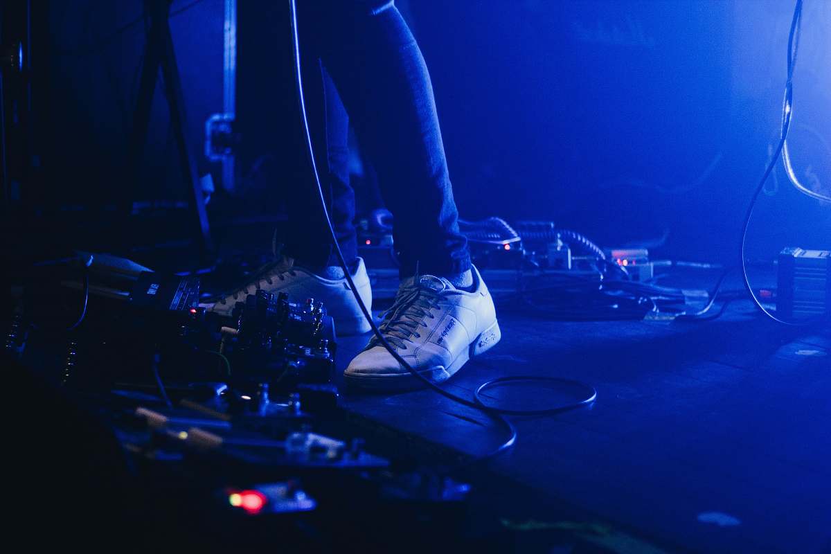 blue person wearing white low-top sneakers foot