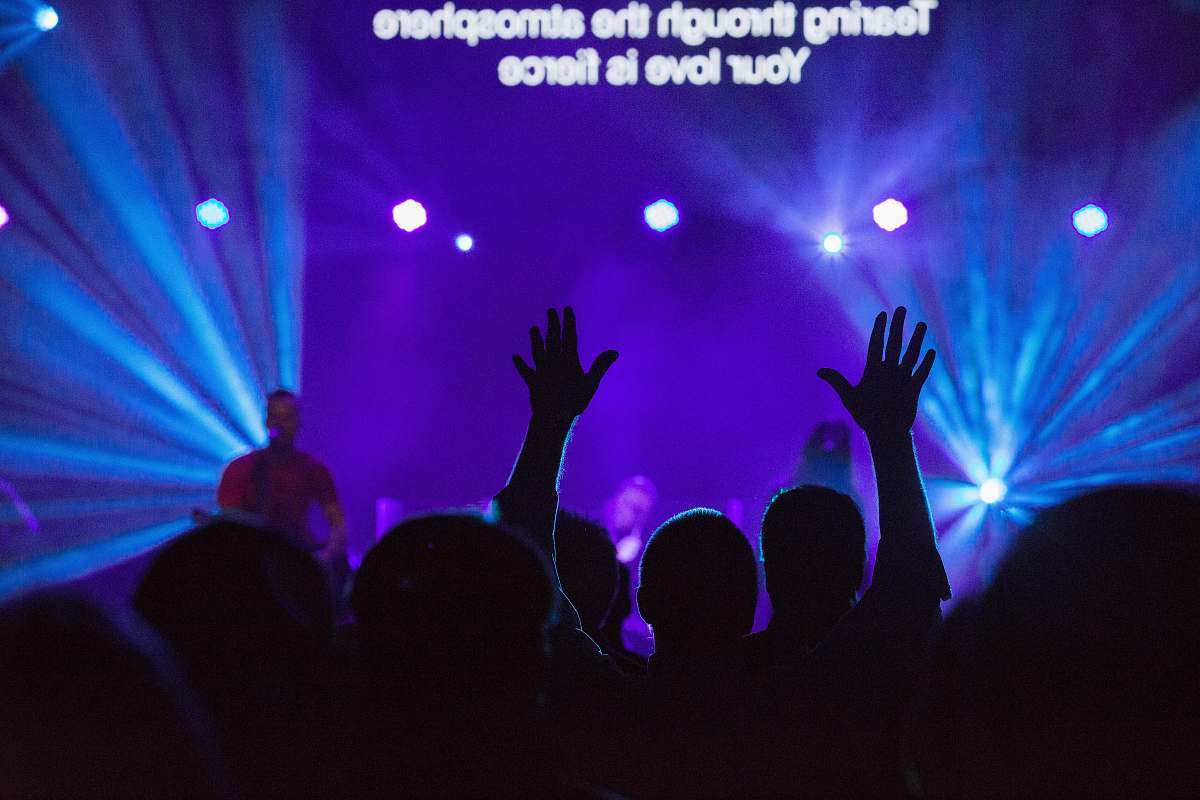 concert silhouette of people against purple background purple