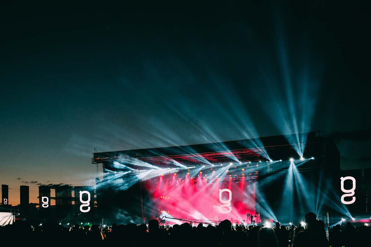 stage silhouette of people and stage lights during nighttime festival