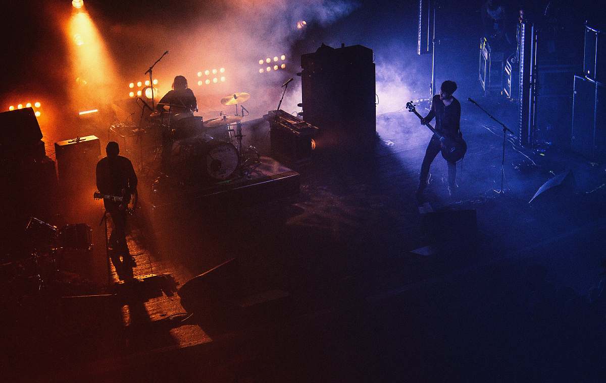 Stage Three People Playing Assorted Instruments On Stage Concert Image ...