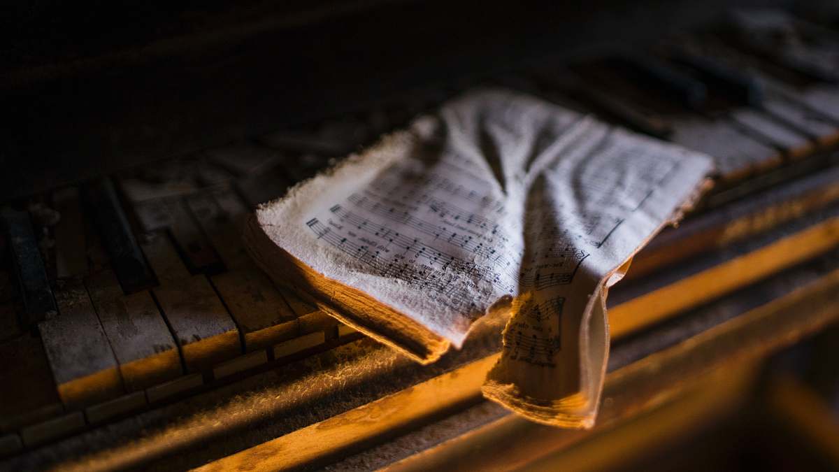 decay torn music sheet on piano keys brownsville