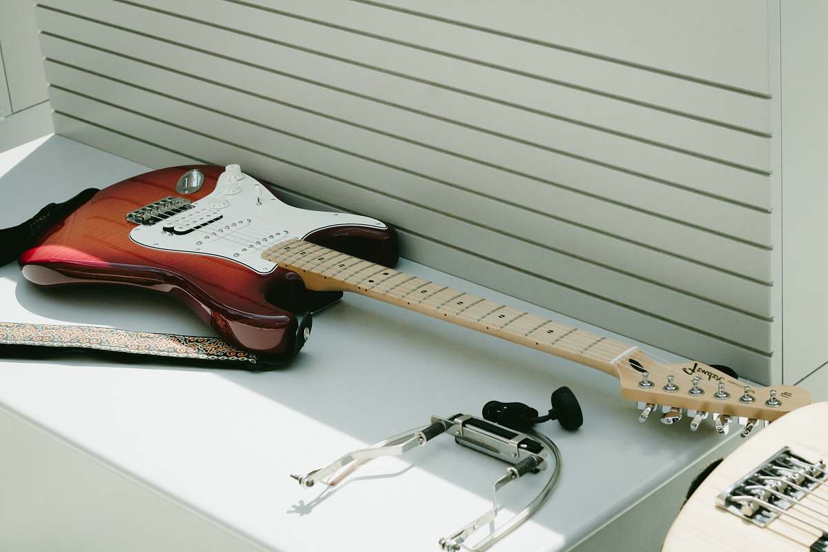guitar white and brown electric guitar on top of white wooden surface electric guitar