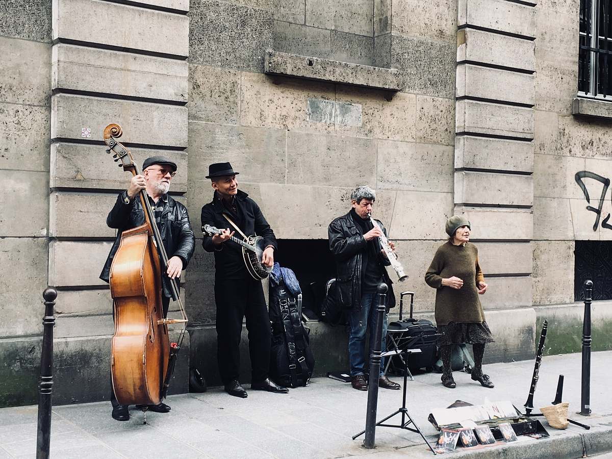 human four men playing instruments musical instrument
