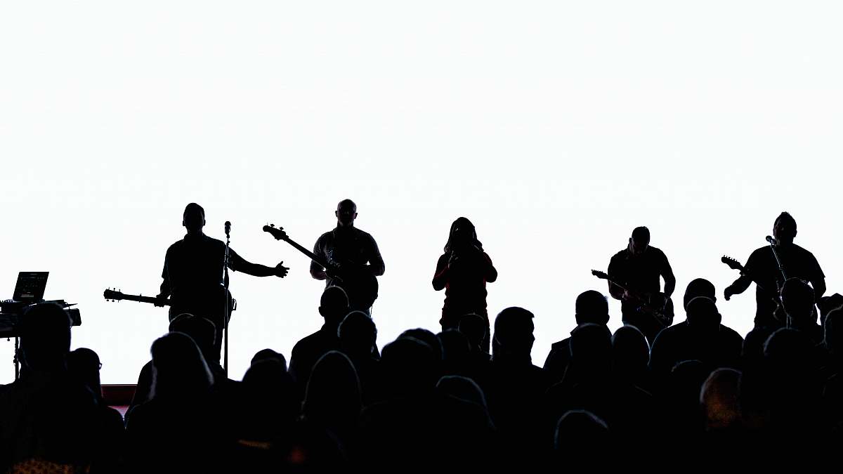 human silhouette of people standing on top of mountain musical instrument