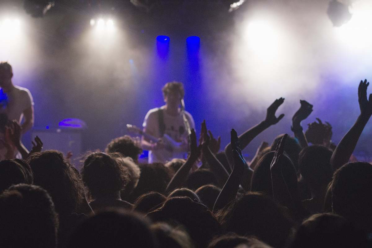 person man playing guitar crowd