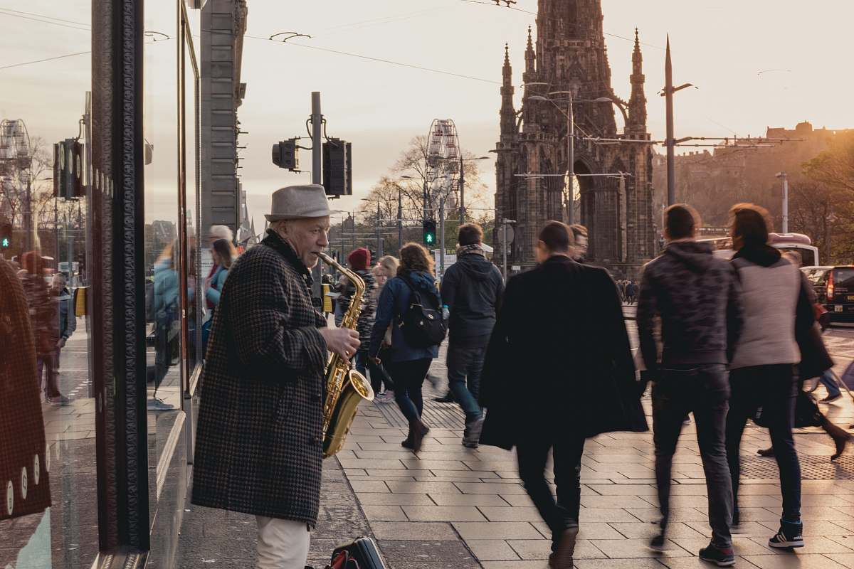 person person playing saxophone in front of people human