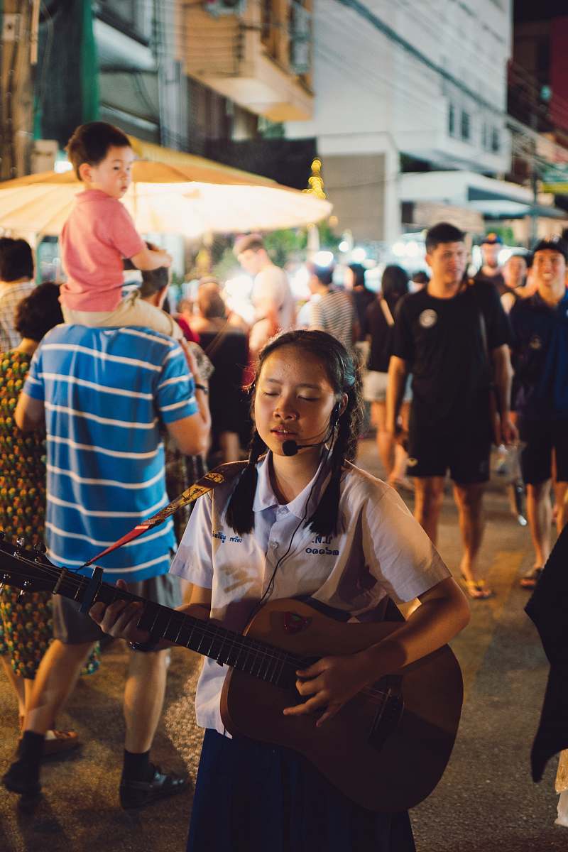 person selective focus photo of girl playing guitar and singing human